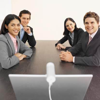 business executives in a meeting, using videoconferencing