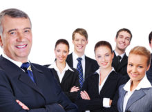 portrait of senior  businessman with successful group of business people, on white background