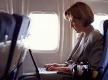 dvtgettywoman on plane with laptop