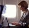 dvtgettywoman on plane with laptop