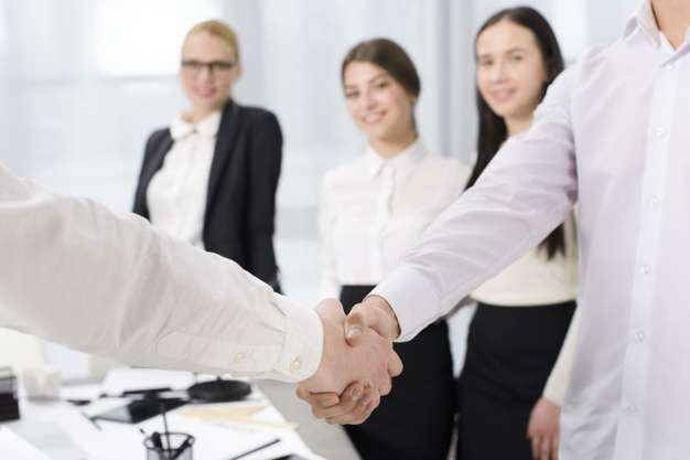 two-business-partners-shaking-hands-office_23-2148073319