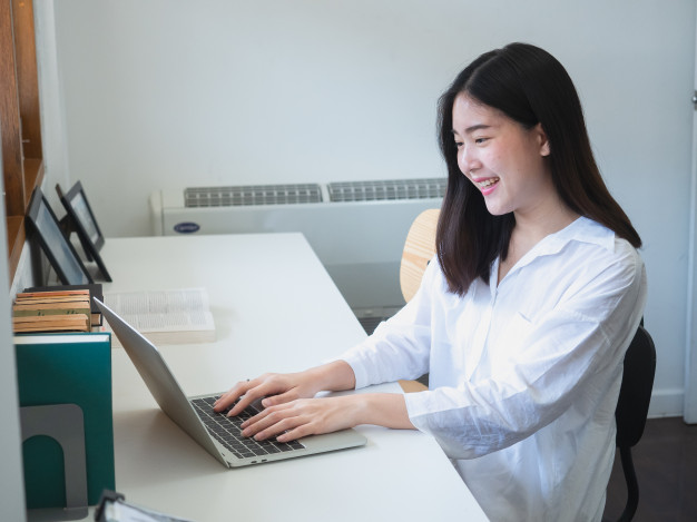 young-asian-woman-working-with-computer-room_44905-634