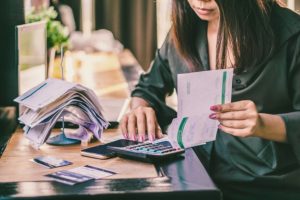 asian-woman-with-financial-bills-calculating-debt_34670-735