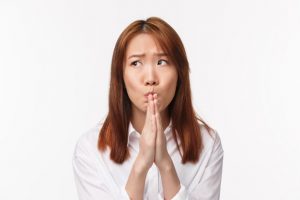 close-up-portrait-timid-nervous-young-asian-woman-white-shirt-standing-worried-hold-hands-pray-look-away-anxiously-frowning-upset-make-wish-come-true-supplicating-white-wall_1258-13408