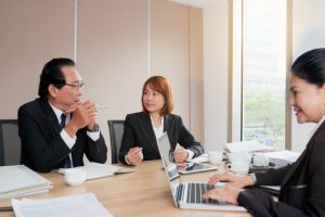 group-asian-business-people-sitting-around-meeting-table-talking_1098-18575